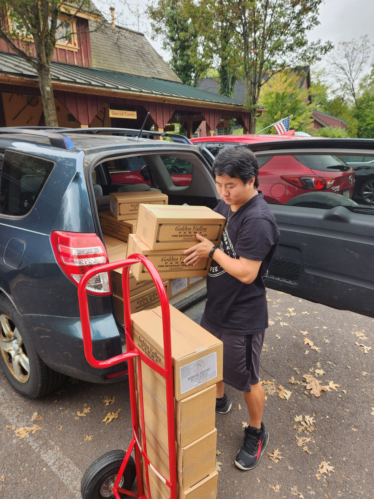 Josiah unloading boxes of Third Horse Coffee for delivery