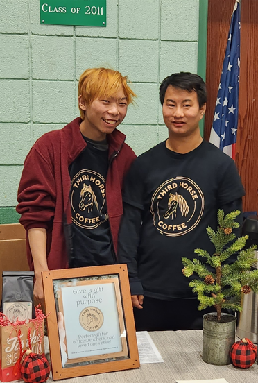 Josiah and Charlie volunteering with Third Horse Coffee at a community event