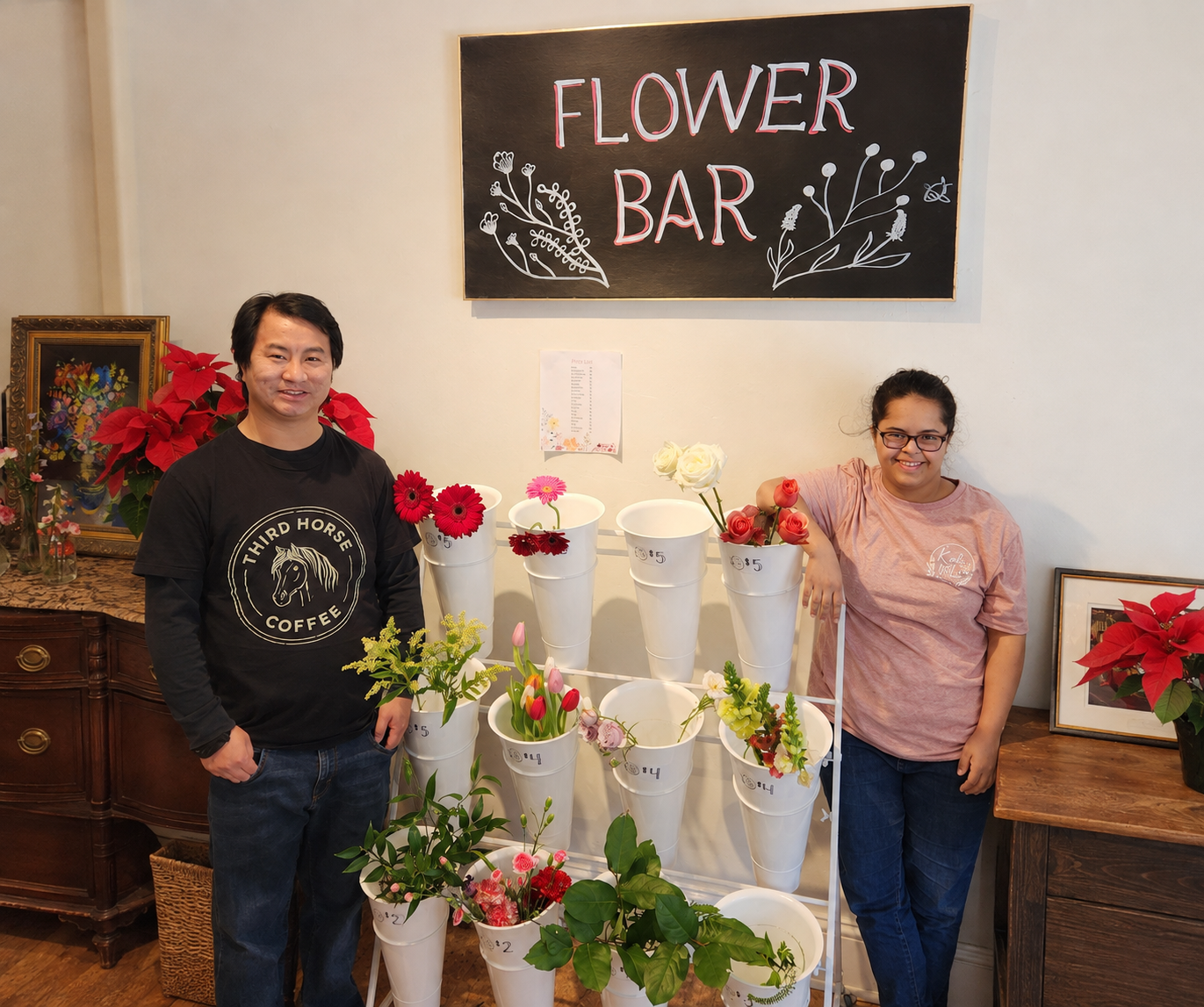 Josiah from Third Horse Coffee with an employee at Kati Mac Floral Designs beside the shop’s flower bar.