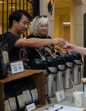 Josiah serving Third Horse Coffee at a community event