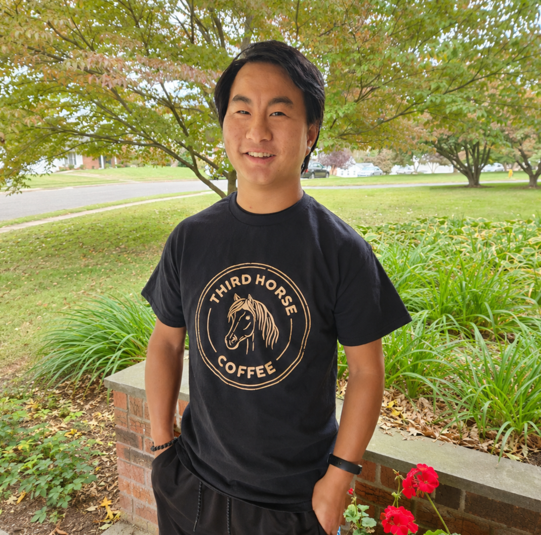 Josiah, the inspiration behind Third Horse Coffee, wearing a Third Horse Coffee shirt