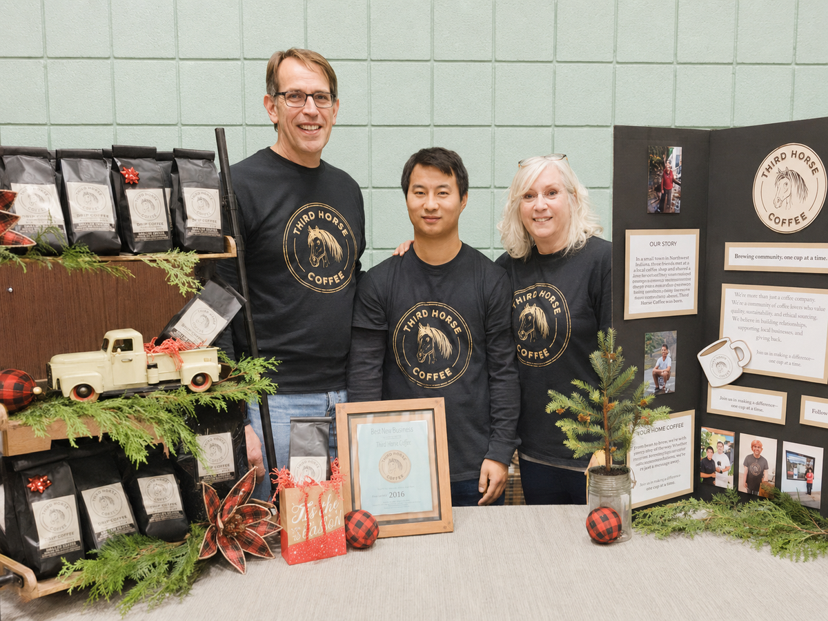 Third Horse Coffee founders Mark and Beth with Josiah at a community event