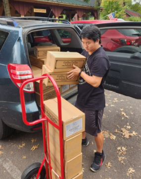 Josiah unloading Third Horse Coffee for delivery to So Much To Give Café