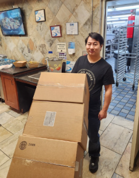 Josiah delivering Third Horse Coffee to White Horse Village, a community partner